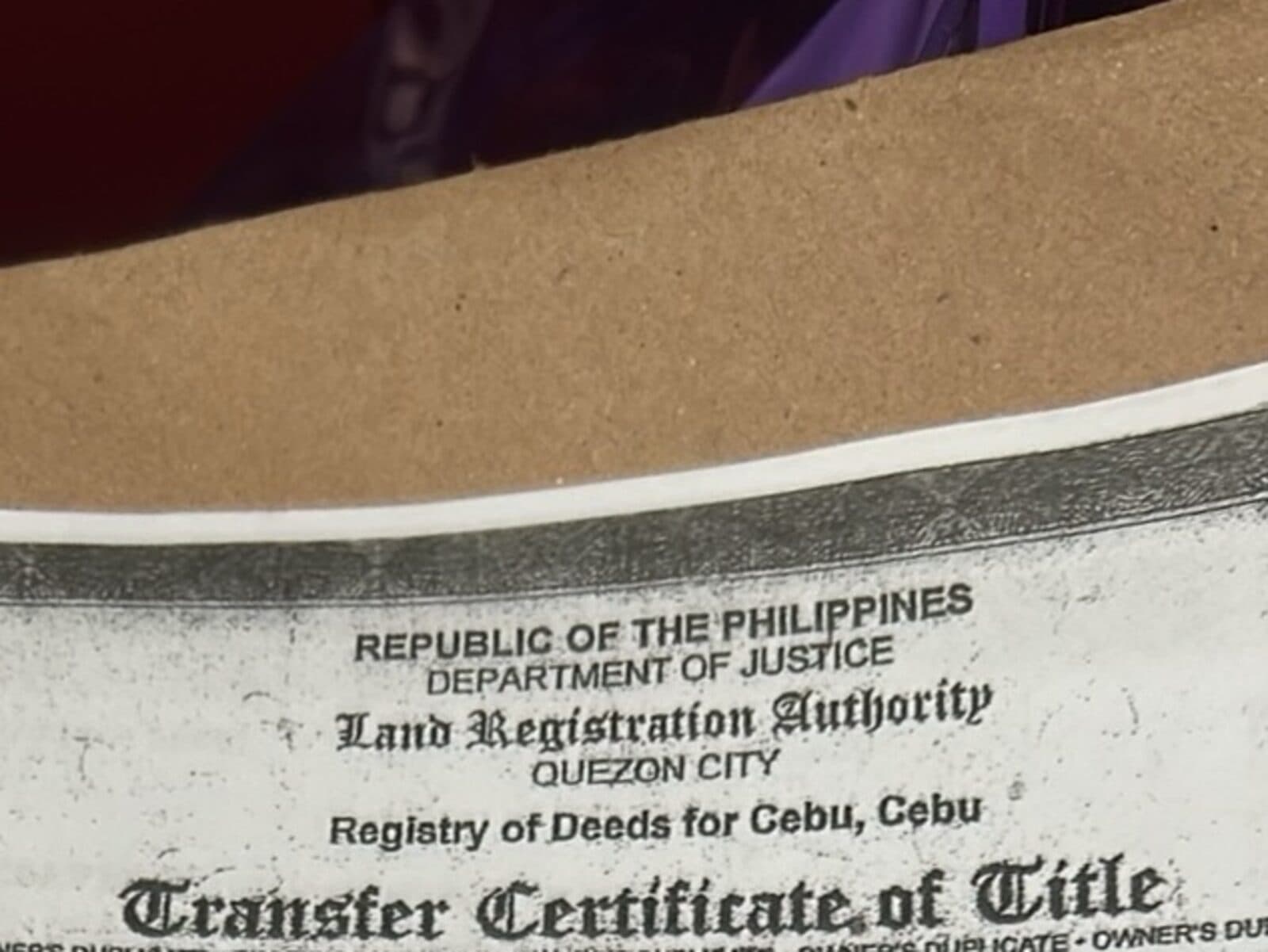 Letterhead of a Land Registration Authority owner's duplicate Transfer Certificate of Title, photographed on a folder, with all identifying numbers cropped out of frame